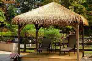 A gazebo with synthetic thatch roofing.