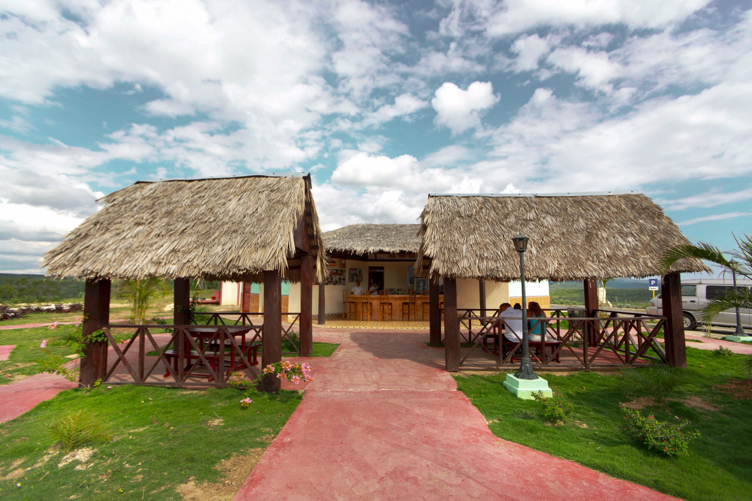 How Should I Compare Synthetic and Natural Thatch for a Resort Cabana Roof in Florida?